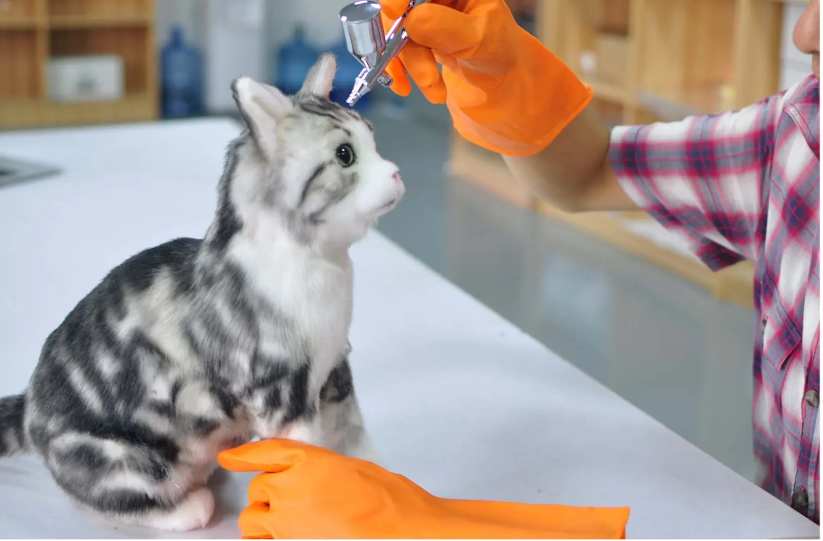 DragonMoss artist adding detailed markings to a custom cat plush