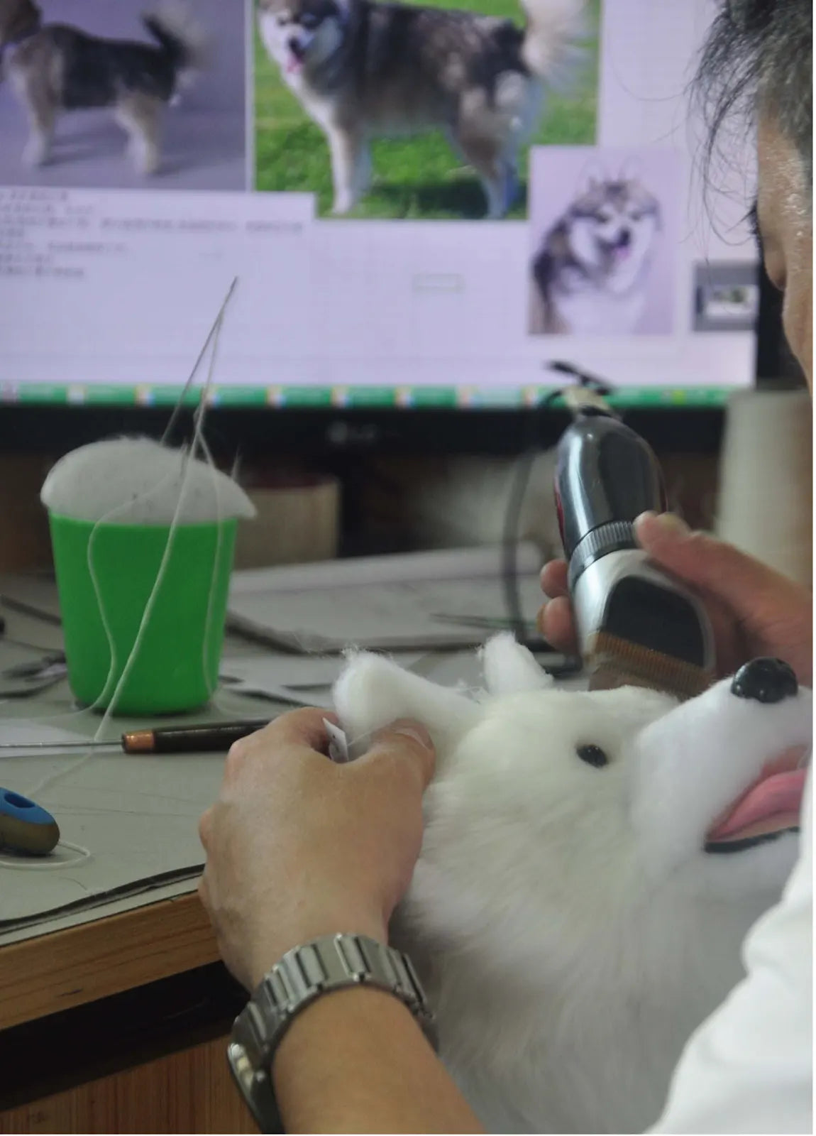 DragonMoss artist trimming fur on a handmade pet plush